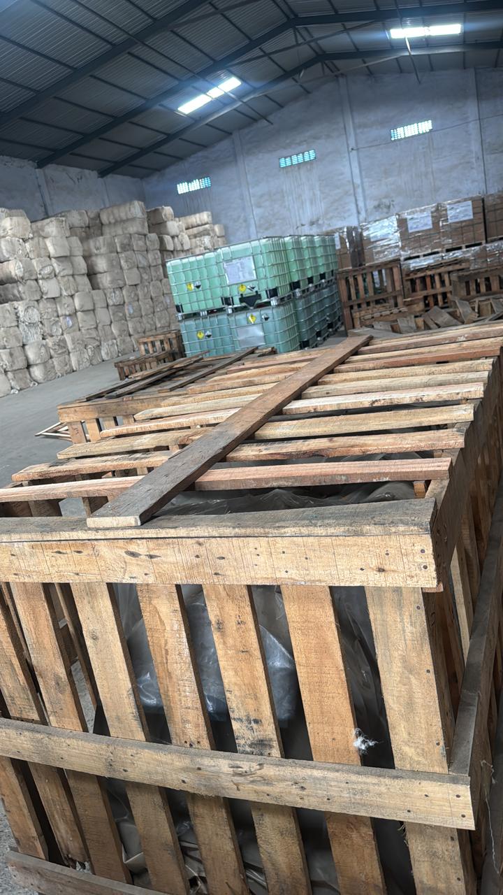 Wooden crates, IBC tanks and bales stored in a warehouse